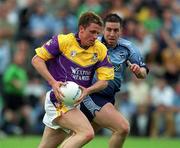 1 June 2002; Diarmuid Kinsella of Wexford in action against Jonathan Magee of Dublin during the Bank of Ireland Leinster Senior Football Championship Quarter-Final match between Wexford and Dublin at Dr. Cullen Park in Carlow. Photo by Damien Eagers/Sportsfile