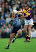 1 June 2002; Jonathan Magee of Dublin in action against Jack Berry of Wexford during the Bank of Ireland Leinster Senior Football Championship Quarter-Final match between Wexford and Dublin at Dr. Cullen Park in Carlow. Photo by Damien Eagers/Sportsfile