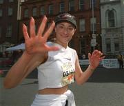 3 June 2002; A participant waves to photographers as she finishes the Tesco Evening Herald Women's Mini Marathon in Dublin. Photo by Pat Murphy/Sportsfile