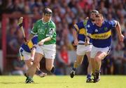 2 June 2002; TJ Ryan of Limerick in action against Tipperary's John Carroll during the Guinness Munster Senior Hurling Championship Semi-Final match between Tipperary and Limerick at Páirc Uí Chaoimh in Cork. Photo by Brendan Moran/Sportsfile