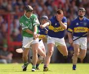 2 June 2002; TJ Ryan of Limerick in action against Tipperary's John Carroll during the Guinness Munster Senior Hurling Championship Semi-Final match between Tipperary and Limerick at Páirc Uí Chaoimh in Cork. Photo by Brendan Moran/Sportsfile