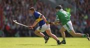 2 June 2002; John Carroll of Tipperary in action against TJ Ryan of Limerick during the Guinness Munster Senior Hurling Championship Semi-Final match between Tipperary and Limerick at Páirc Uí Chaoimh in Cork. Photo by Brendan Moran/Sportsfile