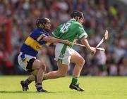 2 June 2002; James Butler of Limerick in action against Tipperary's Donnacha Fahy during the Guinness Munster Senior Hurling Championship Semi-Final match between Tipperary and Limerick at Páirc U’ Chaoimh in Cork. Photo by Brendan Moran/Sportsfile