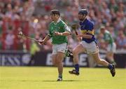 2 June 2002; TJ Ryan of Limerick in action against Tipperary's Thomas Dunne during the Guinness Munster Senior Hurling Championship Semi-Final match between Tipperary and Limerick at Páirc Uí Chaoimh in Cork. Photo by Brendan Moran/Sportsfile