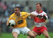 2 June 2002; Joe Quinn of Antrim in action against Derry's Johnny McBride during the Bank of Ireland Ulster Senior Football Championship Quarter-Final match between Antrim and Derry at Casement Park in Belfast. Photo by Brian Lawless/Sportsfile