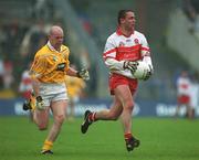 2 June 2002; Ciaran McNally of Derry in action against Anto Finnegan of Antrim during the Bank of Ireland Ulster Senior Football Championship Quarter-Final match between Antrim and Derry at Casement Park in Belfast. Photo by Brian Lawless/Sportsfile