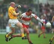 2 June 2002; Ciaran McNally of Derry, in action against Anto Finnegan of Antrim during the Bank of Ireland Ulster Senior Football Championship Quarter-Final match between Antrim and Derry at Casement Park in Belfast. Photo by Brian Lawless/Sportsfile