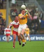 2 June 2002; Martin McCarry of Antrim in action against Derry's Ciaran McNally during the Bank of Ireland Ulster Senior Football Championship Quarter-Final match between Antrim and Derry at Casement Park in Belfast. Photo by Brian Lawless/Sportsfile