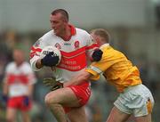 2 June 2002; Dermot Dougan of Derry in action against Enda McLernon of Antrim during the Bank of Ireland Ulster Senior Football Championship Quarter-Final match between Antrim and Derry at Casement Park in Belfast. Photo by Brian Lawless/Sportsfile
