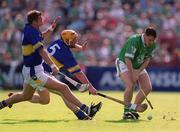 2 June 2002; Peter Lawlor of Limerick in action against Tipperary's Eamonn Corcoran, centre, and Brian O'Meara during the Guinness Munster Senior Hurling Championship Semi-Final match between Tipperary and Limerick at Páirc U’ Chaoimh in Cork. Photo by Brendan Moran/Sportsfile