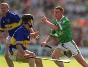2 June 2002; Ciaran Carey of Limerick in action against Tipperary's Thomas Dunne during the Guinness Munster Senior Hurling Championship Semi-Final match between Tipperary and Limerick at Páirc Uí Chaoimh in Cork. Photo by Brendan Moran/Sportsfile