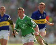 2 June 2002; Ciaran Carey of Limerick in action against Tipperary's Conor Gleeson during the Guinness Munster Senior Hurling Championship Semi-Final match between Tipperary and Limerick at Páirc U’ Chaoimh in Cork. Photo by Brendan Moran/Sportsfile