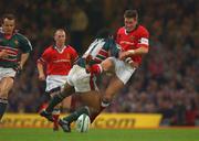 25 May 2002; Ronan O'Gara of Munster is tackled by Freddie Tuilagi of Leicester Tigers during the Heineken Cup Final match between Leicester Tigers and Munster at the Millennium Stadium in Cardiff, Wales. Photo by Matt Browne/Sportsfile