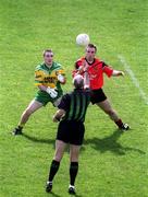 2 June 2002; Referee Gerry Kinneavy throws the ball in between John Gildea of Donegal and Brian Burns of Down at the throw in during the Bank of Ireland Ulster Senior Football Championship Quarter-Final match between Donegal and Down at MacCumhail Park in Ballybofey, Donegal. Photo by Damien Eagers/Sportsfile