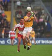 2 June 2002; Martin McCarry of Antrim in action against Ciaran McNally of Derry during the Bank of Ireland Ulster Senior Football Championship Quarter-Final match between Antrim and Derry at Casement Park in Belfast. Photo by Brian Lawless/Sportsfile