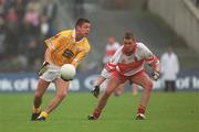 2 June 2002; Gearoid Adams of Antrim in action against Gavin Diamond of Derry during the Bank of Ireland Ulster Senior Football Championship Quarter-Final match between Antrim and Derry at Casement Park in Belfast. Photo by Brian Lawless/Sportsfile