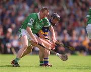 2 June 2002; Eoin O'Neill of Limerick in action against Thomas Dunne of Tipperary during the Guinness Munster Senior Hurling Championship Semi-Final match between Tipperary and Limerick at Páirc Uí Chaoimh in Cork. Photo by Brendan Moran/Sportsfile