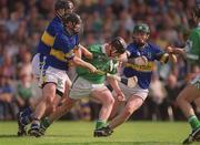 2 June 2002; James Butler of Limerick in action against Philip Maher, left, Donnacha Fahy and David Kennedy of Tipperary during the Guinness Munster Senior Hurling Championship Semi-Final match between Tipperary and Limerick at Páirc U’ Chaoimh in Cork. Photo by Brendan Moran/Sportsfile