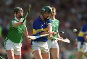 2 June 2002; David Kennedy of Tipperary in action against Brian Begley of Limerick during the Guinness Munster Senior Hurling Championship Semi-Final match between Tipperary and Limerick at Páirc U’ Chaoimh in Cork. Photo by Brendan Moran/Sportsfile