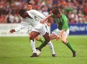 16 May 2002; Isaac Okoronkwo of Nigeria is tackled by Republic of Ireland's Robbie keane during the International Friendly match between Republic of Ireland and Nigeria at Lansdowne Road in Dublin. Photo by Matt Browne/Sportsfile