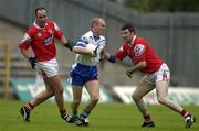 8 June 2002; Jason Hughes of Monaghan is tackled by Ken Reilly, right, and Seamus O'Hanlon of Louth during the Bank of Ireland All-Ireland Senior Football Championship Qualifier Round 1 match between Monaghan and Louth at St Tiernach's Park in Clones, Monaghan. Photo by Brendan Moran/Sportsfile