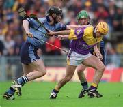 9 June 2002; Wexford's Michael Jordan is tackled by Stephen Perkins, left, and Philip Brennan of Dublin during the Guinness Leinster Senior Hurling Championship Semi-Final match between Wexford and Dublin at Semple Stadium in Thurles, Tipperary. Photo by Ray McManus/Sportsfile