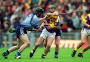 9 June 2002; Wexford's Michael Jordan is tackled by Stephen Perkins, left, and Philip Brennan of Dublin during the Guinness Leinster Senior Hurling Championship Semi-Final match between Wexford and Dublin at Semple Stadium in Thurles, Tipperary. Photo by Ray McManus/Sportsfile