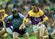 9 June 2002; Larry O'Gorman of Wexford is tackled by Stephen Perkins of Dublin during the Guinness Leinster Senior Hurling Championship Semi-Final match between Wexford and Dublin at Semple Stadium in Thurles, Tipperary. Photo by Aoife Rice/Sportsfile