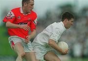 26 May 2002; Damien Hendy of Kildare in action against Christy Grimes of Louth during the Bank of Ireland Leinster Senior Football Championship Quarter-Final match between Kildare and Louth  at Páirc Tailteann in Navan, Meath. Photo by Ray McManus/Sportsfile