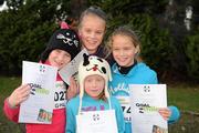 25 December 2011; Susie Lynch, nine years, left, from Foxrock, Dublin, with her sisters, Alice, 12, Lucy, 10, and Isabel, 7, after finishing one of the many GOAL Mile's. Annual Goal Mile, Leopardstown Race Course, Dublin. Picture credit: Ray McManus / SPORTSFILE