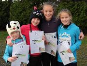 25 December 2011; Isabel Lynch, seven years, left, from Foxrock, Dublin, with her sisters, Susie, 9, Alice, 12, and Lucy, 10, after finishing one of the many GOAL Mile's. Annual Goal Mile, Leopardstown Race Course, Dublin. Picture credit: Ray McManus / SPORTSFILE