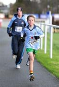25 December 2011; Thirteen year old 'Dubs' supporter, Fergus O'Rourke, 0166, from Killiney, finishing one of the many GOAL Mile's. Annual Goal Mile, Leopardstown Race Course, Dublin. Picture credit: Ray McManus / SPORTSFILE