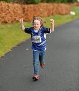 25 December 2011; Six year old Helen Reynolds, from Goatstown, Dublin, finishing one of the many GOAL Mile's. Annual Goal Mile, Leopardstown Race Course, Dublin. Picture credit: Ray McManus / SPORTSFILE