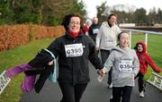 25 December 2011; Yvonne Reynolds, from Goatstown, and her daughter Hannah finishing one of the many GOAL Mile's. Annual Goal Mile, Leopardstown Race Course, Dublin. Picture credit: Ray McManus / SPORTSFILE
