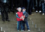 29 December 2011; Two young race goers look on during the Ballymaloe Country Relish Beginners Steeplechase. Leopardstown Christmas Racing Festival 2011, Leopardstown Racecourse, Leopardstown, Dublin. Picture credit: Brian Lawless / SPORTSFILE