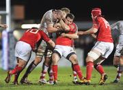 30 December 2011; Scott Deasy, Munster, centre, with support of team-mates Ian Keatley, left, and Billy Holland is tackled by Lewis Stevenson, Ulster. Celtic League, Ulster v Munster, Ravenhill Park, Belfast, Co. Antrim. Picture credit: Oliver McVeigh / SPORTSFILE