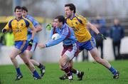 8 January 2012; Johnny Duane, GMIT, in action against Cathal Dineen, right, and Sean Purcell, Roscommon. FBD Insurance League, Section B, Round 1, G.M.I.T. v Roscommon, St Aidan's GAA Club, Ballyforan, Co. Roscommon. Picture credit: Brian Lawless / SPORTSFILE