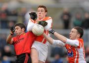 8 January 2012; Marcus Miskelly, Down, contests for possession against Charlie Vernon, and Sean Moore, right, Armagh. Dr. McKenna Cup, Section B, Down v Armagh, Pairc Esler, Newry, Co. Down. Picture credit: Oliver McVeigh / SPORTSFILE