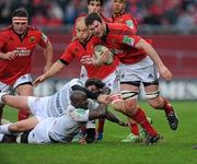 14 January 2012; Donnacha Ryan, Munster, is tackled by Marc-Antoine Rallier and Ibrahim Diarra, Castres Olympique. Heineken Cup, Pool 1, Round 5, Munster v Castres Olympique, Thomond Park, Limerick. Picture credit: Matt Browne / SPORTSFILE