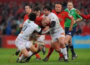 14 January 2012; Paul O'Connell, Munster, is tackled by Pierre Bernard, left, and Marc-Antoine Rallier, right, Castres Olympique. Heineken Cup, Pool 1, Round 5, Munster v Castres Olympique, Thomond Park, Limerick. Picture credit: Diarmuid Greene / SPORTSFILE
