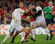 14 January 2012; James Coughlan, Munster, is tackled by Jannie Bornman, right, and Saimone Taumoepeau, Castres Olympique. Heineken Cup, Pool 1, Round 5, Munster v Castres Olympique, Thomond Park, Limerick. Picture credit: Matt Browne / SPORTSFILE