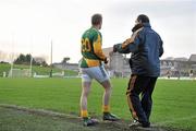 15 January 2012; Graham Geraghty, Meath selector and player, prepares to come on as a substitute during the second half of the game beside manager Seamus McEnaney. Bord na Mona O'Byrne Cup, Quarter-Final, Meath v Louth, Pairc Tailteann, Navan, Co. Meath. Picture credit: David Maher / SPORTSFILE