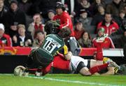 21 January 2012; Johne Murphy, Munster, goes over to score his side's second try, despite the efforts of Ben Foden, Northampton Saints. Heineken Cup, Pool 1 Round 6, Northampton Saints v Munster, Franklin's Gardens, Northampton, England. Picture credit: Matt Impey / SPORTSFILE