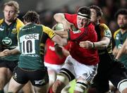 21 January 2012; James Coughlan, Munster, is tackled by Ryan Lamb, left, and Phil Dowson, Northampton Saints. Heineken Cup, Pool 1 Round 6, Northampton Saints v Munster, Franklin's Gardens, Northampton, England. Picture credit: Matt Impey / SPORTSFILE