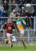 11 June 2017; Niall McNamee of Offaly kicks a point as Mark McCallon of Westmeath closes in during the Leinster GAA Football Senior Championship Quarter-Final match between Offaly and Westmeath at Bord Na Móna O'Connor Park, Tullamore, in Co. Offaly. Photo by Piaras Ó Mídheach/Sportsfile