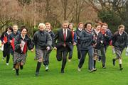 26 January 2012; Senator Eamonn Coghlan, race director, takes a run through the park with transition year students, from Presentation College Terenure, in attendance at the 2012 Kleinwort Benson Investors St. Patrick’s 5k Festival Road Race launch photocall. Merrion Square Park, Merrion Square, Dublin. Picture credit: Ray McManus / SPORTSFILE