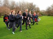 26 January 2012; Senator Eamonn Coghlan, race director, takes a run through the park with transition year students, from Presentation College Terenure, in attendance at the 2012 Kleinwort Benson Investors St. Patrick’s 5k Festival Road Race launch photocall. Merrion Square Park, Merrion Square, Dublin. Picture credit: Ray McManus / SPORTSFILE