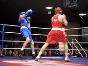 27 January 2012; John Joe Nevin, right, Cavan Boxing Club, knocks down Sean McComb, Holy Trinity Boxing Club, during the third round of their 56kg bout. 2012 National Elite Boxing Championship Semi-Finals, National Stadium, Dublin. Picture credit: David Maher / SPORTSFILE