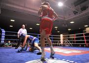 27 January 2012; Darren O'Neill, right, Paulstown Boxing Club, knocks down Conrad Cummings, Holy Trinity Boxing Club, during their 75kg bout. 2012 National Elite Boxing Championship Semi-Finals, National Stadium, Dublin. Picture credit: David Maher / SPORTSFILE