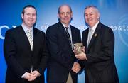 28 January 2012; Uachtarán CLG Criostóir Ó Cuana presents Jim Doyle on behalf of Andy O'Brien, from Wicklow, with his Christy Ring award, alongside Alan Smullen, General Manager, Croke Park Hotel. The Christy Ring, Nicky Rackard & Lory Meagher Champion 15 Awards 2011, Croke Park, Dublin. Picture credit: Barry Cregg / SPORTSFILE